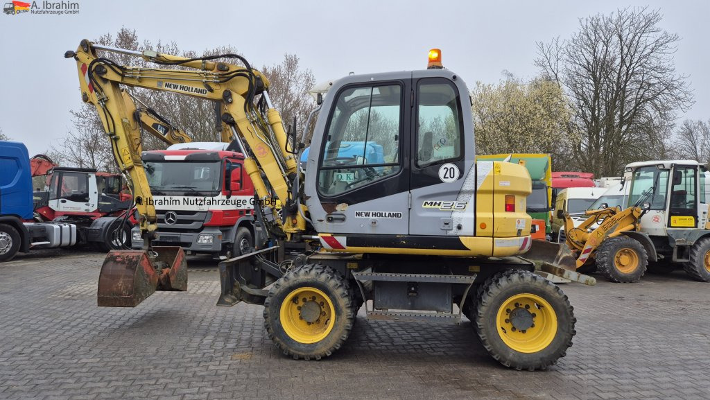 New Holland MH 2.6 Zustand gut, deutsche Maschine incl. Greifer und Dreservo - Excavadora de ruedas: foto 1 New Holland MH 2.6 Zustand gut, deutsche Maschine incl. Greifer und Dreservo - Excavadora de ruedas: foto 1
